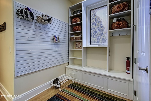 mudroom featuring wood finished floors, visible vents, and baseboards