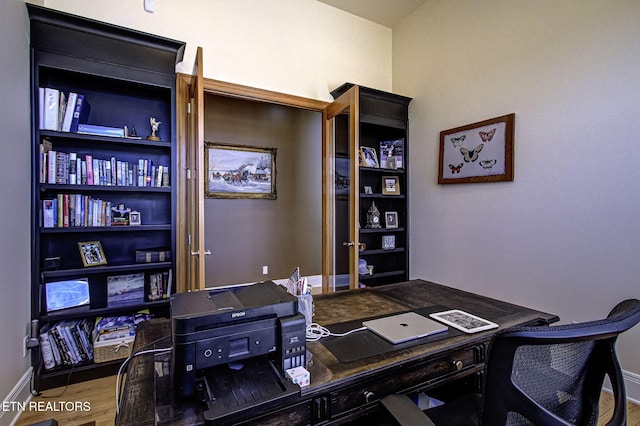 office featuring baseboards and wood finished floors