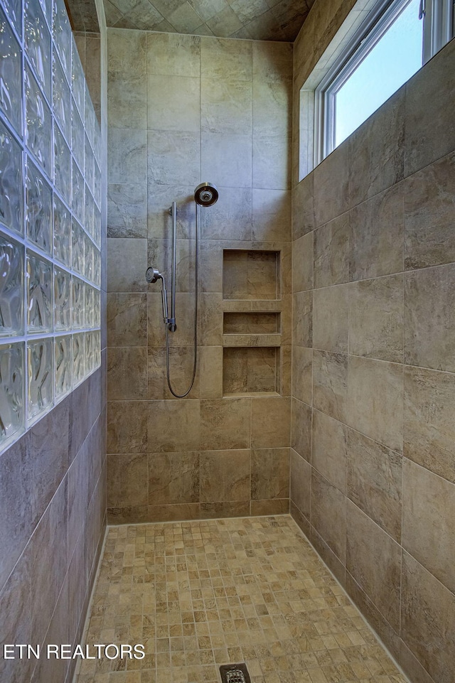 bathroom with a tile shower