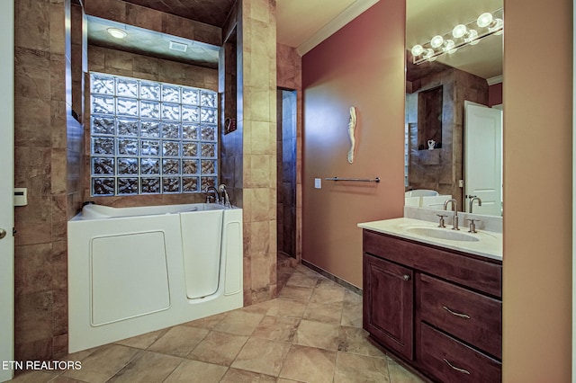 bathroom featuring a garden tub, visible vents, and vanity