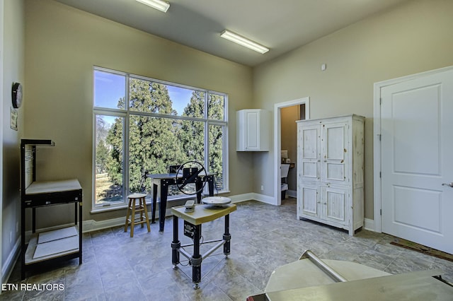 home office with a high ceiling and baseboards