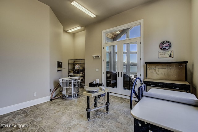 office area with high vaulted ceiling, baseboards, and french doors