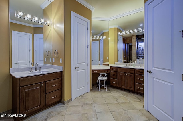 bathroom featuring crown molding, two vanities, and a sink