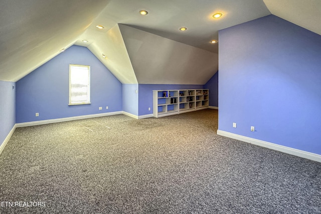 bonus room with lofted ceiling, carpet floors, and baseboards