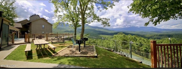 view of property's community featuring a mountain view and a lawn