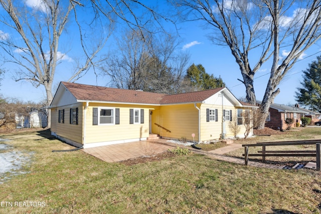 back of property featuring a patio and a yard