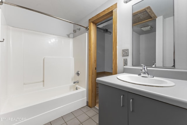 bathroom with tile patterned flooring, vanity, and bathtub / shower combination