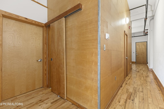 hallway with light hardwood / wood-style flooring