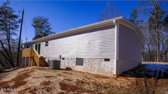 view of side of property with central AC