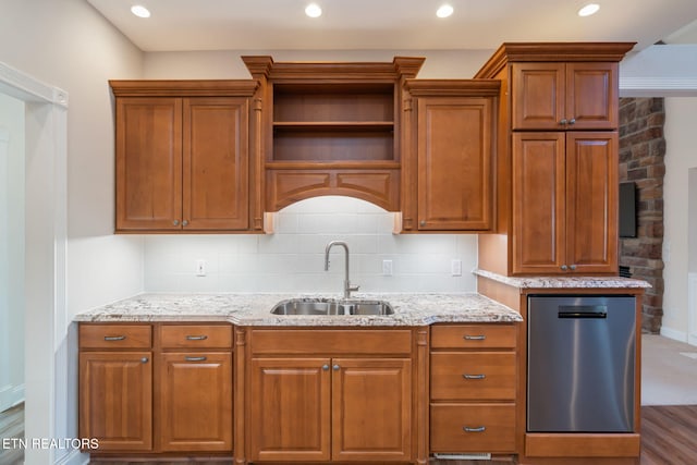 kitchen featuring sink, stainless steel dishwasher, light stone counters, and decorative backsplash