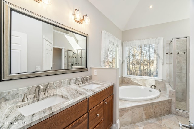 bathroom featuring vanity, independent shower and bath, and vaulted ceiling