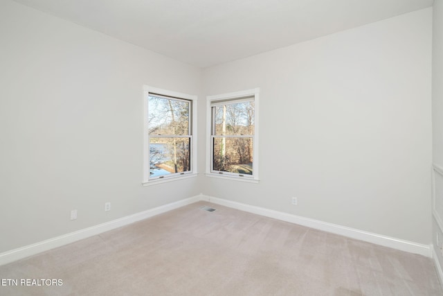 empty room with light colored carpet