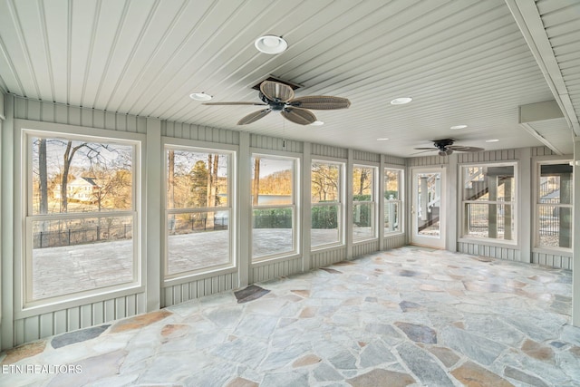 unfurnished sunroom featuring ceiling fan