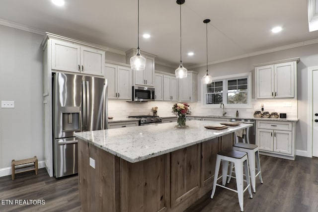 kitchen featuring white cabinetry, sink, a center island, and appliances with stainless steel finishes