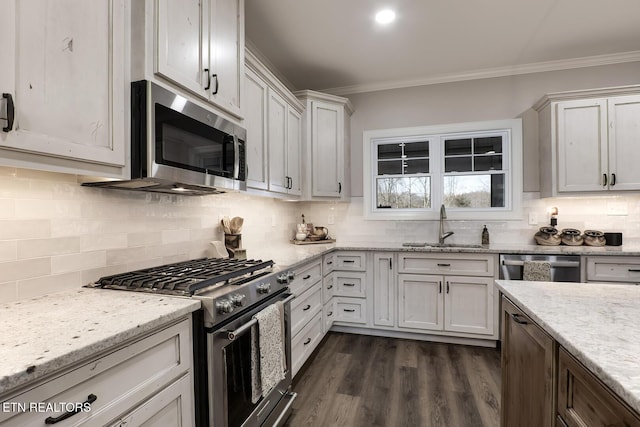 kitchen with crown molding, appliances with stainless steel finishes, sink, and white cabinets