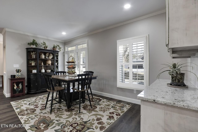 dining area with ornamental molding and dark hardwood / wood-style flooring