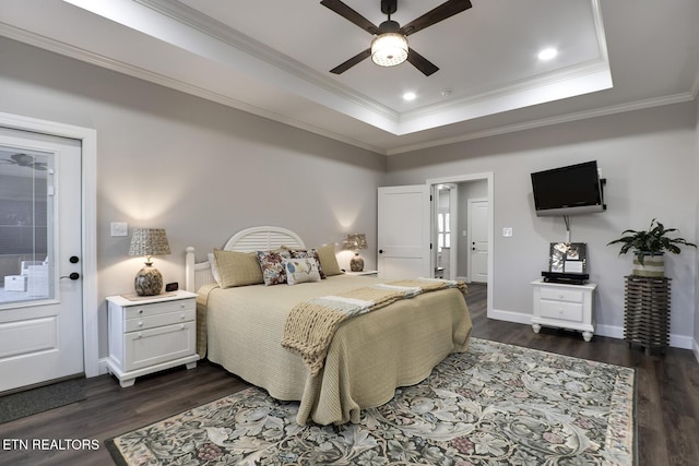 bedroom featuring ceiling fan, ornamental molding, dark hardwood / wood-style flooring, and a raised ceiling