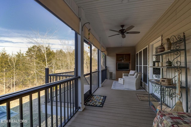 wooden deck with ceiling fan and an outdoor hangout area