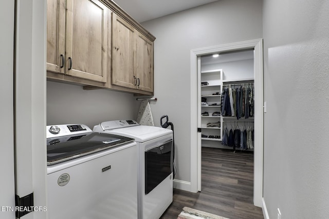 washroom with cabinets, dark wood-type flooring, and washer and clothes dryer