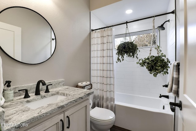 full bathroom featuring vanity, shower / bathtub combination with curtain, and toilet