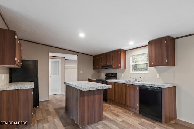 kitchen with sink, crown molding, a center island, light wood-type flooring, and black appliances