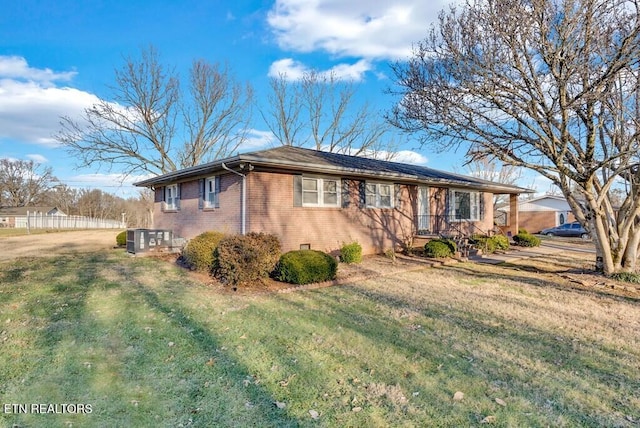 ranch-style home featuring central AC and a front lawn