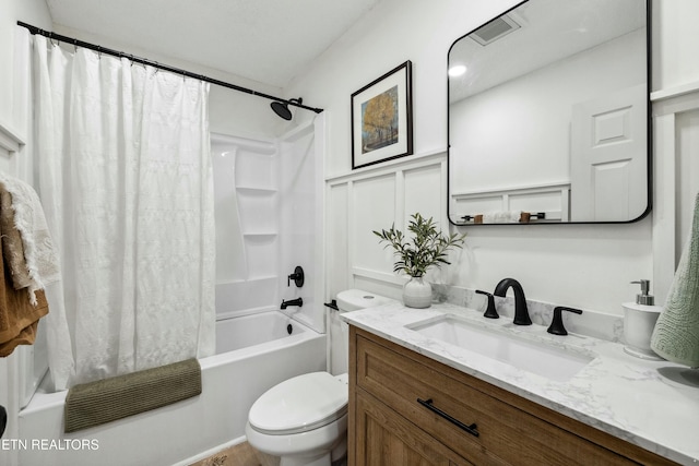 full bathroom featuring vanity, shower / bath combination with curtain, and toilet