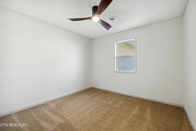 carpeted empty room with a textured ceiling and ceiling fan