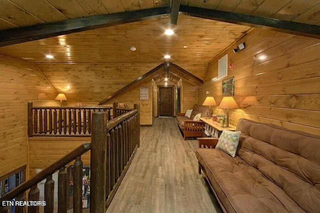 interior space featuring wood-type flooring, wooden walls, lofted ceiling with beams, and wooden ceiling