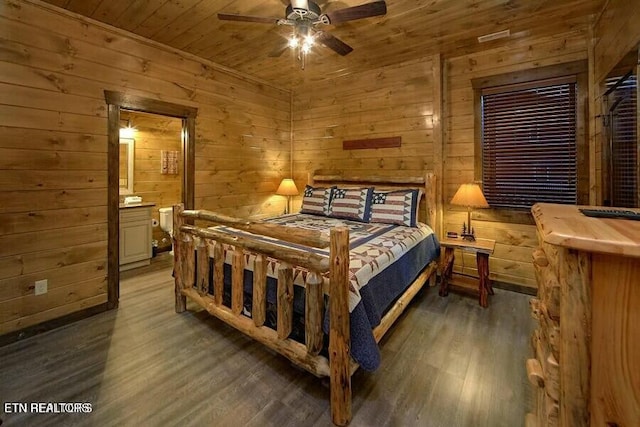 bedroom featuring dark hardwood / wood-style floors, wooden walls, ceiling fan, wood ceiling, and ensuite bath