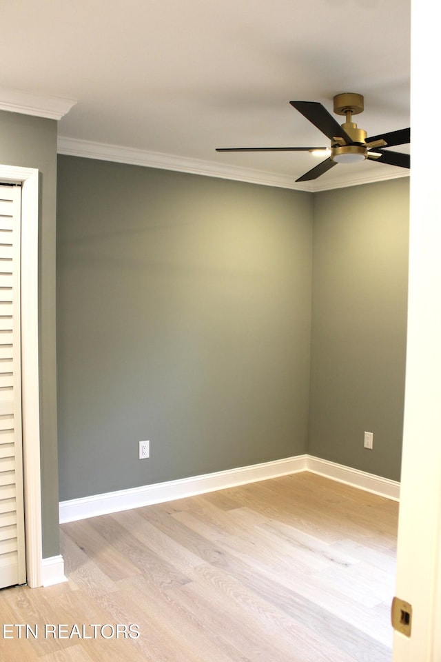 empty room featuring ceiling fan, ornamental molding, and light hardwood / wood-style flooring