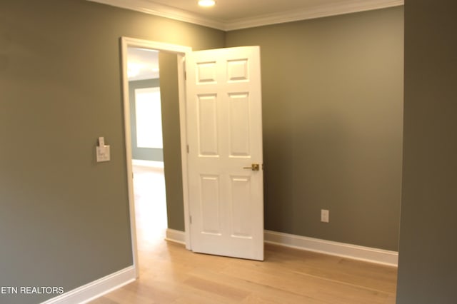 unfurnished room with crown molding and light hardwood / wood-style floors