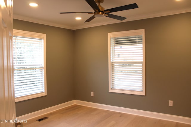 spare room featuring ceiling fan, ornamental molding, and hardwood / wood-style floors