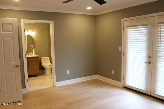 unfurnished bedroom featuring crown molding, connected bathroom, ceiling fan, and light hardwood / wood-style flooring