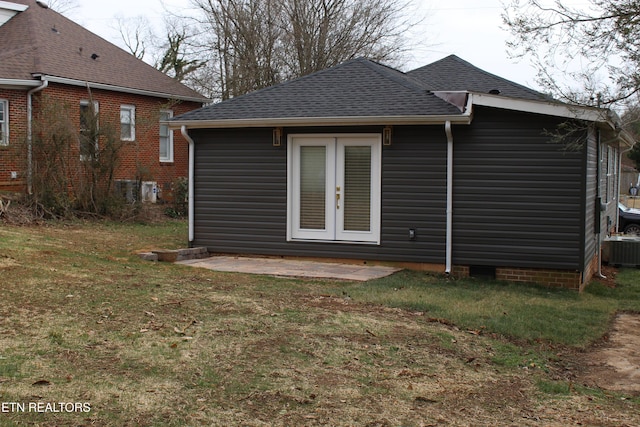 rear view of property with a lawn, a patio area, and french doors