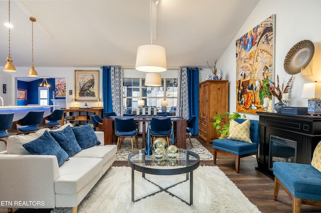 living room featuring lofted ceiling and hardwood / wood-style floors