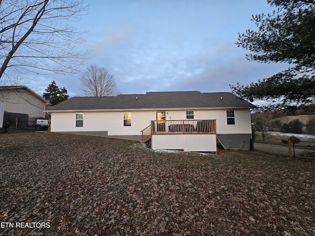 rear view of property featuring a wooden deck