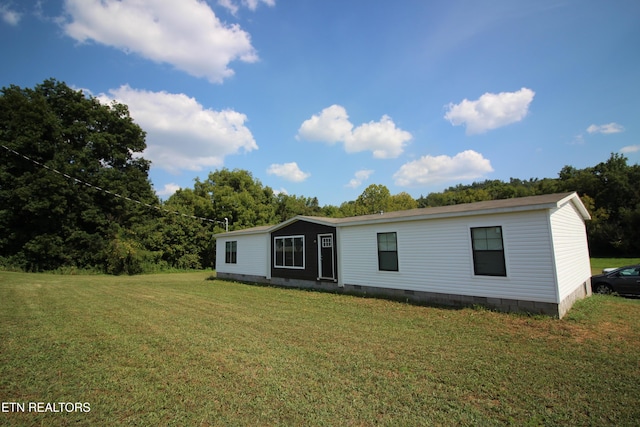 rear view of property with a lawn