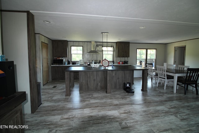 kitchen featuring appliances with stainless steel finishes, pendant lighting, and wall chimney exhaust hood