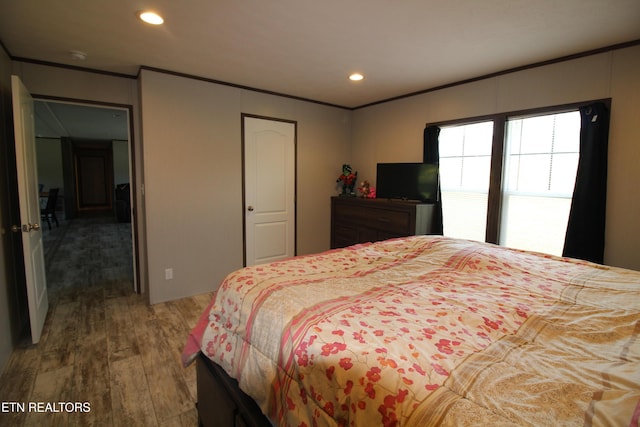 bedroom with hardwood / wood-style floors and a closet