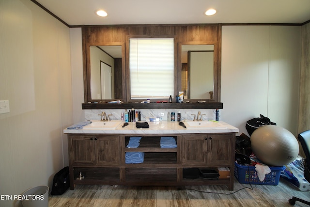 bathroom featuring vanity, hardwood / wood-style flooring, and crown molding