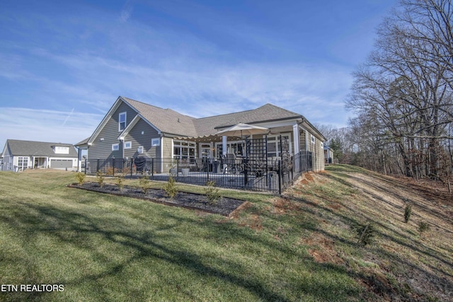 rear view of property with a patio and a yard