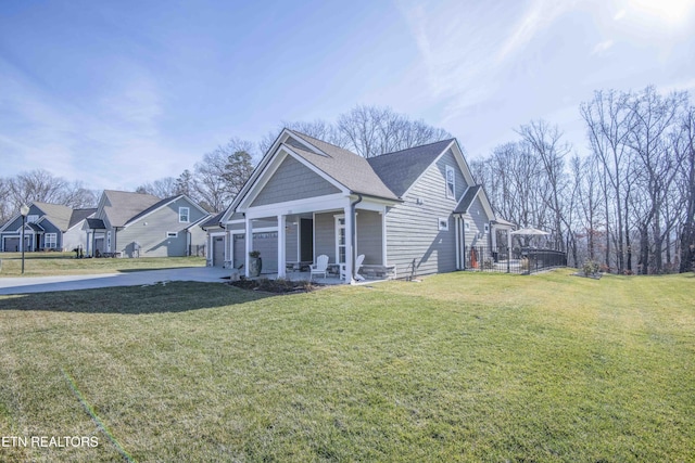 view of side of property with a lawn and a porch