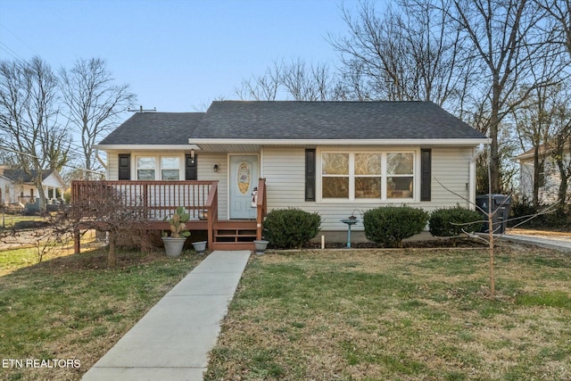 view of front of house featuring a wooden deck and a front lawn