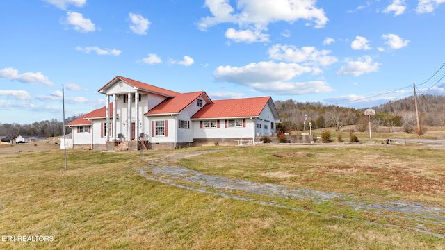 view of front of property featuring metal roof, crawl space, and a front yard