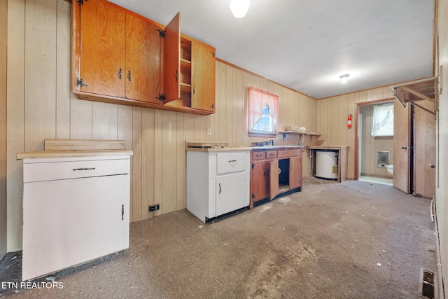 kitchen with brown cabinetry, visible vents, light countertops, and a wealth of natural light