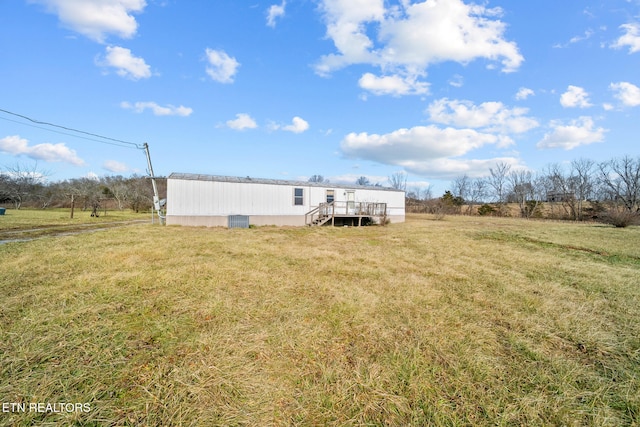 rear view of property featuring a rural view and a yard