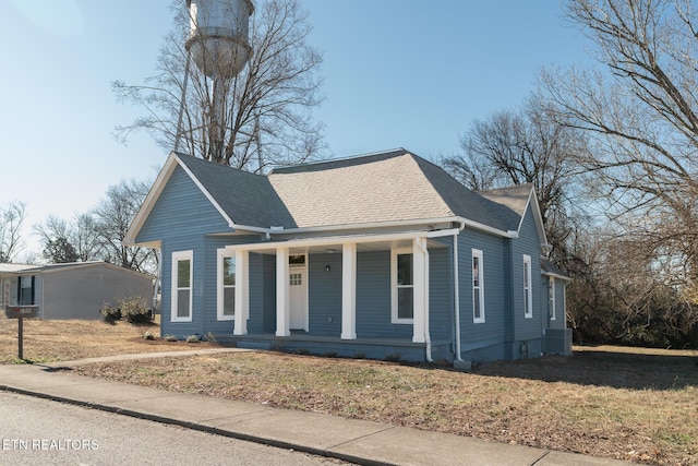 bungalow-style home featuring central AC, a front lawn, and covered porch