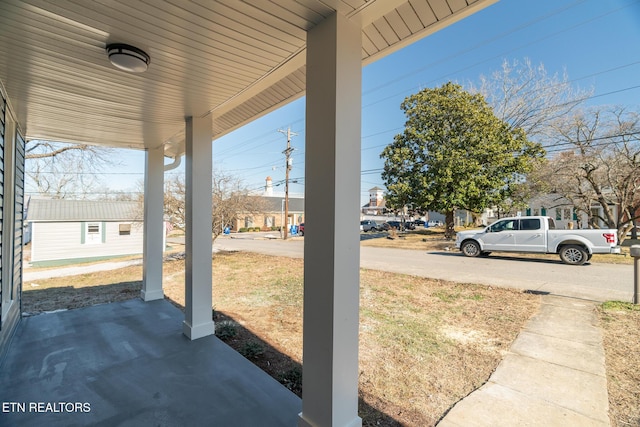 view of yard featuring covered porch