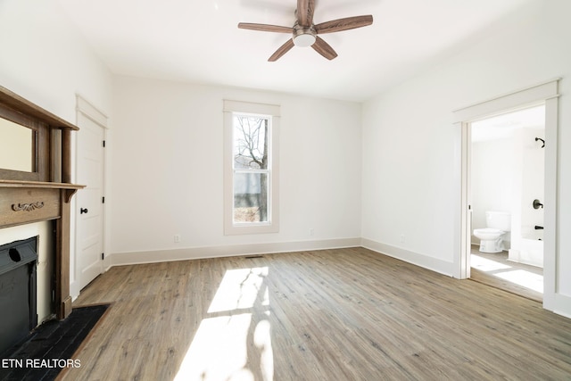 unfurnished living room with ceiling fan and light wood-type flooring